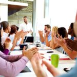 Business people applauding presenter in a meeting