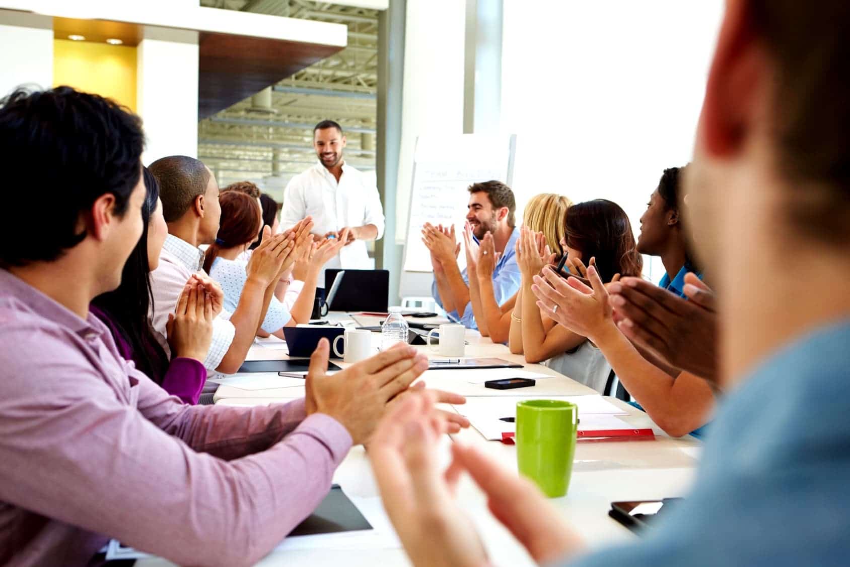 Business people applauding presenter in a meeting
