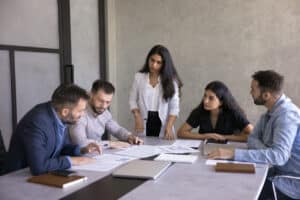 Before You Plan, Know Where You Stand — Inside and Out Group of five professionals engaged in brainstorming or decision-making